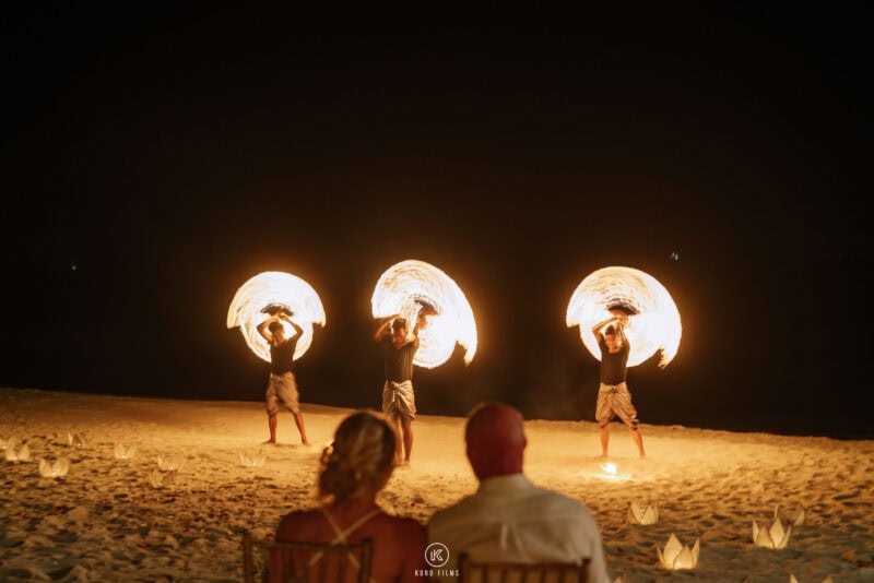 Fire dancers perform on the beach for the wedding guests at night at Baan Puri, Koh Samui