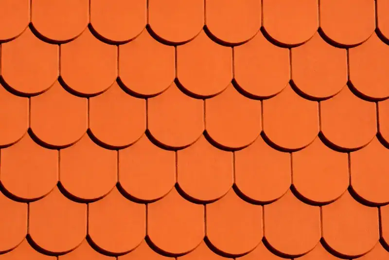 Close-up of overlapping roof shingles in need of repair checks