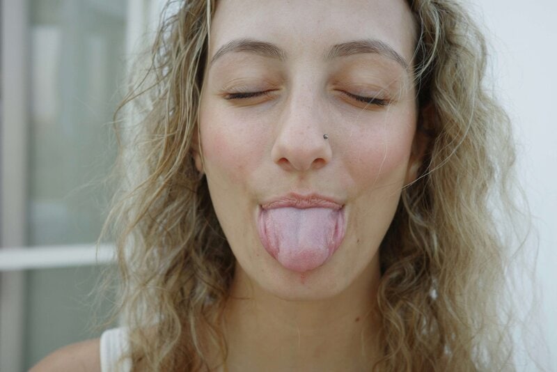 Happy patient smiling after tongue tie removal.