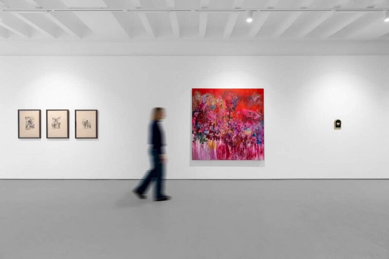 Visitor walking past Wenhui Hao’s vibrant red abstract painting at Berntson Bhattacharjee gallery.