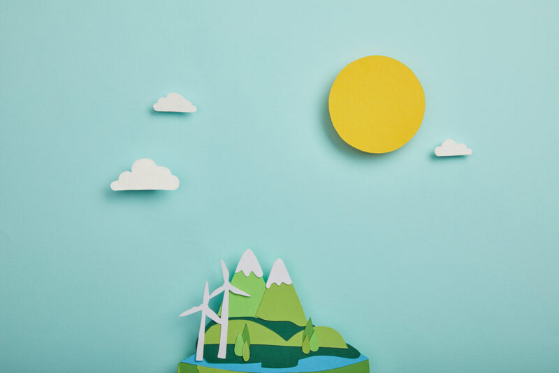 vista superior del planeta de papel cortado con fuentes de energía renovables sobre fondo turquesa, día de la tierra ION Proyectos