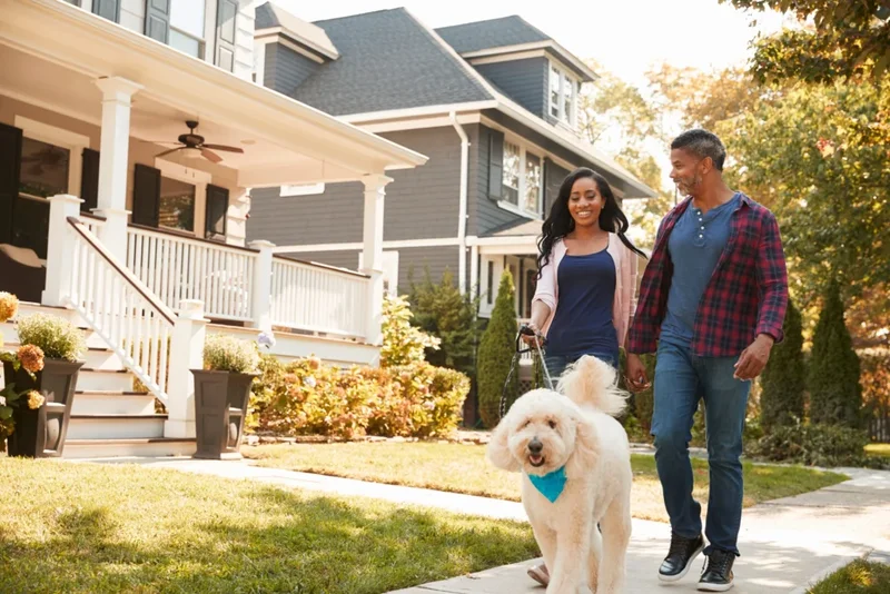 couple walking with dog | what is a hoa