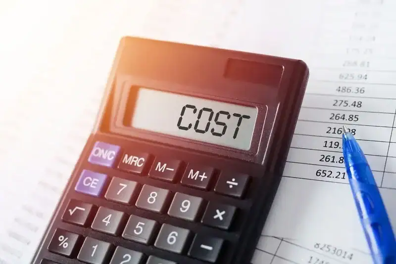 An image of a calculator with "COST" and a blue ballpen