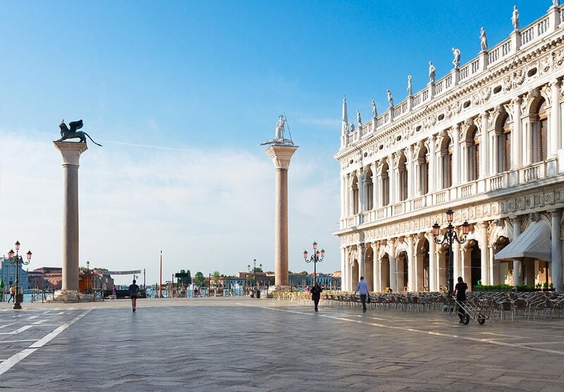Piazza San Marco in Venedig mit den berühmten Säulen des Markuslöwen und San Teodoro sowie der prachtvollen Biblioteca Nazionale Marciana.