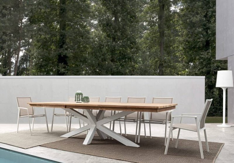 Elegante tavolo da pranzo in legno con sedie bianche in giardino, arredi moderni e minimalisti.