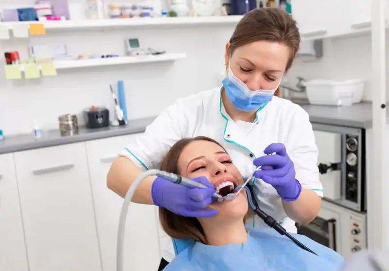 Dentist performing clean up on patient who found them through SEO