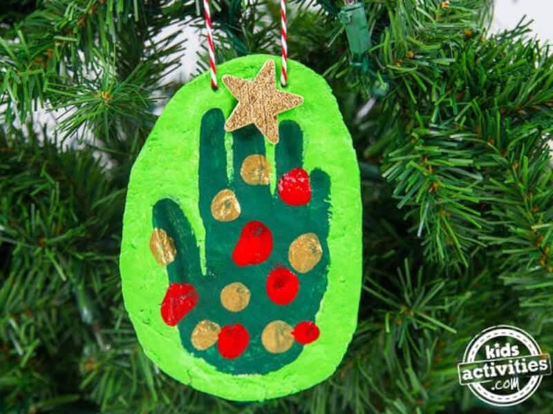 DIY salt dough handprint ornament hanging from Christmas tree