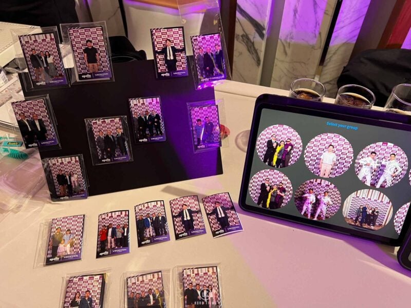 Finished photo magnets on display next to a tablet showing guests' photos