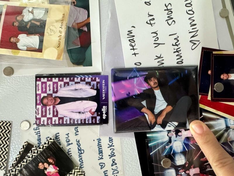 Photo magnets with a custom branded frame on a fridge next to a handwritten thank-you card