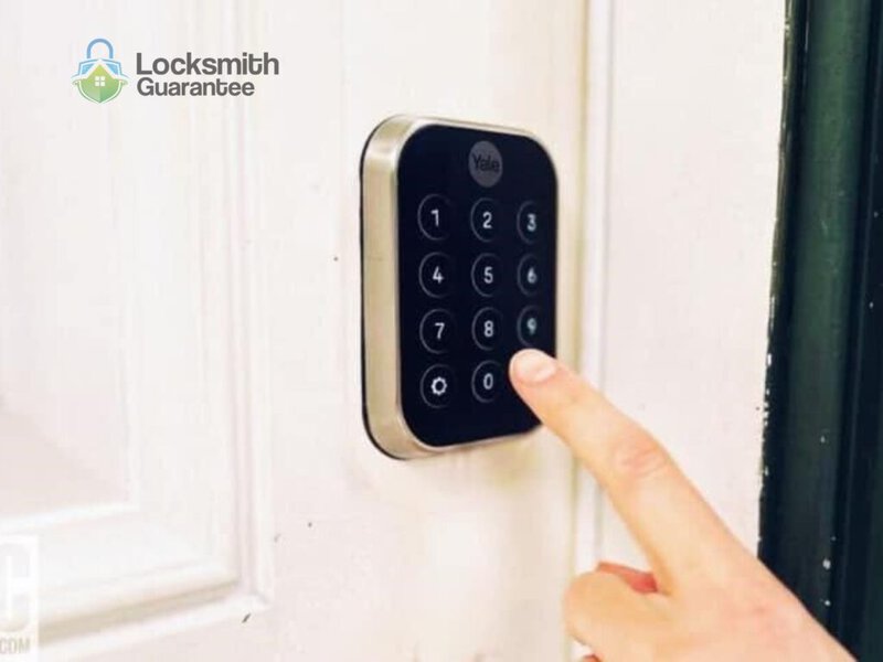 Finger pressing button on a digital door lock keypad.