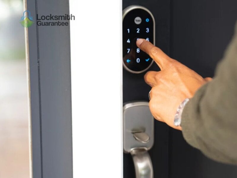 Hand entering code on a smart door lock keypad.