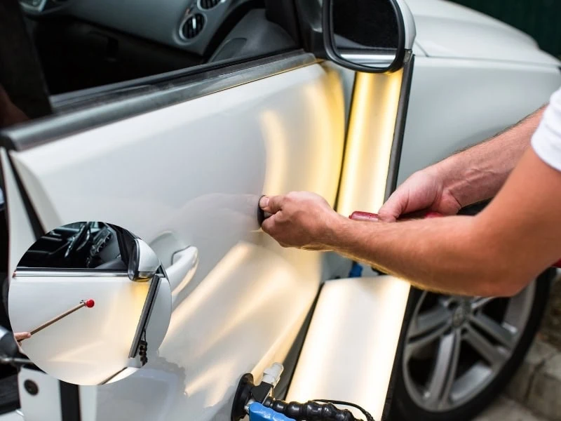 A car with a small dent being repaired, get dent out of car