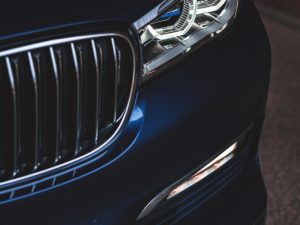 Close-up of a luxury car with no visible bumper dent, showcasing a sleek and polished front grille.