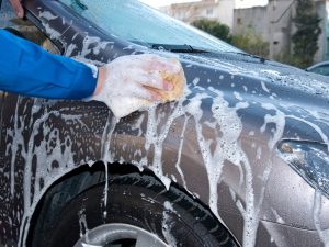 Close-up of car wash, highlighting risk of dent and scratch.