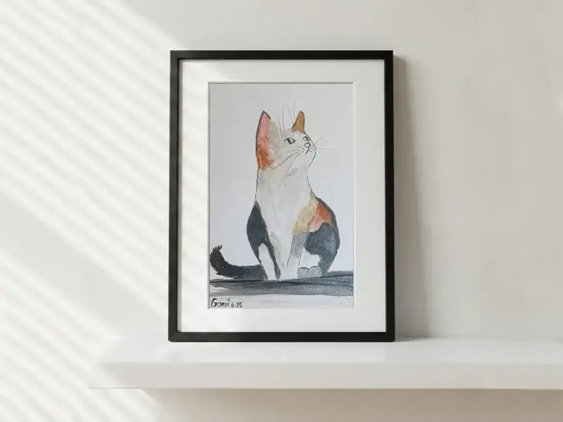 Il gattino calico in attesa, acquarello, china e matita di Gordana Majic con un piccolo gatto pezzato seduto, coda scura arricciata e sguardo rivolto verso l’alto su fondo chiaro.