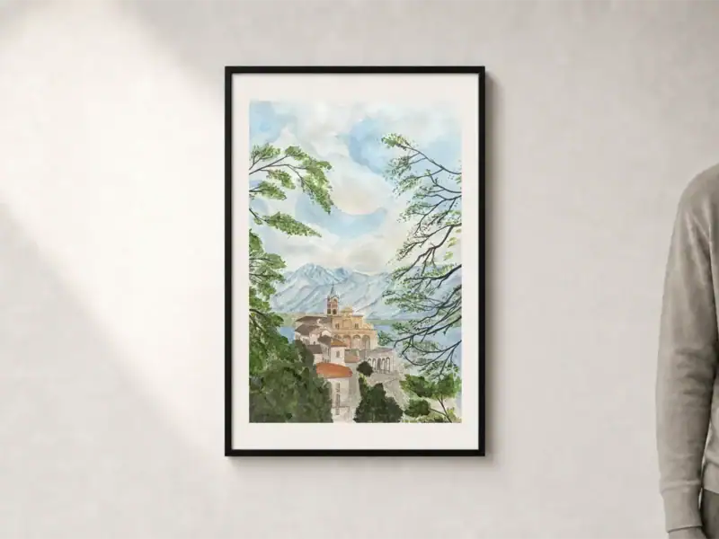 Acquerello colorato della Chiesa Madonna del Sasso sopra Locarno, incorniciata da alberi e rami con montagne azzurre sullo sfondo, presentato con passepartout e cornice nera; dimensioni esterne 52 × 72 cm.