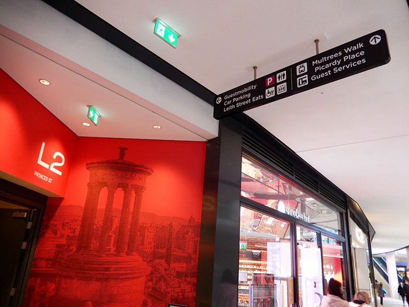 Colour and graphics applied to the lift lobby entrances to aid intuitive wayfinding at St James Quarter Edinburgh