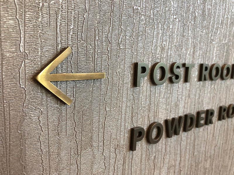Close up of directional prompt signs in Regent's Crescent Apartments