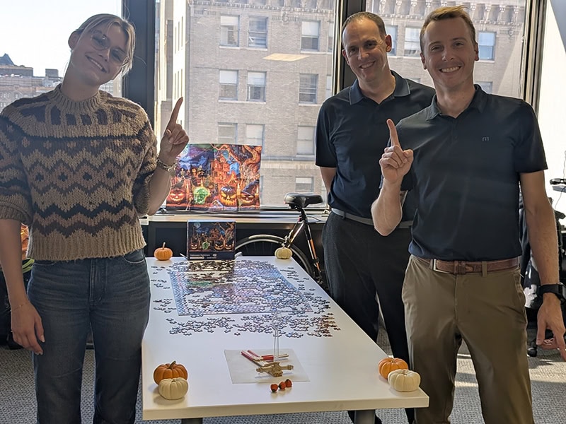 Barton Associates team celebrating an ESOP puzzle competition