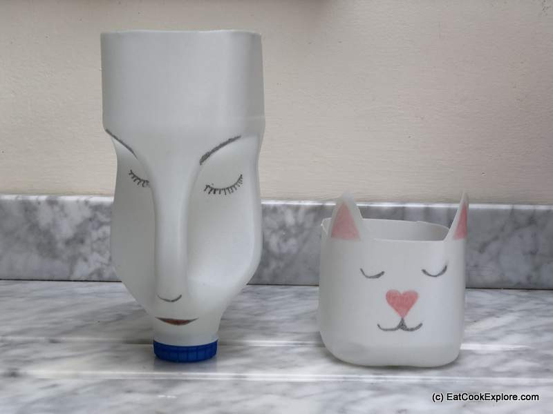 Using some waterproof pens, you can draw in the face. Make it cute by adding eyelashes, a cute nose, etc. I tied a ribbon across the forehead fo the bigger planter. 