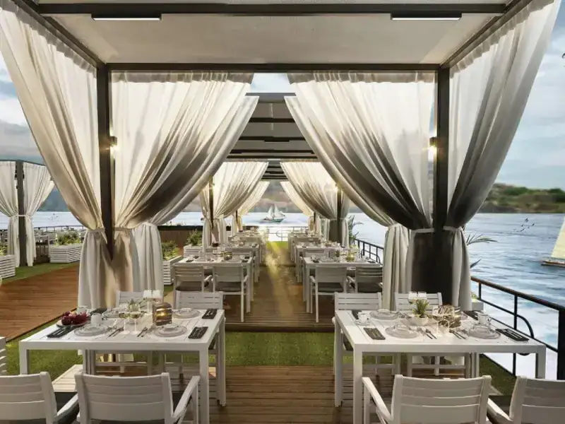 Outdoor dining tables on Liberty Nile Cruise sun deck overlooking the Nile