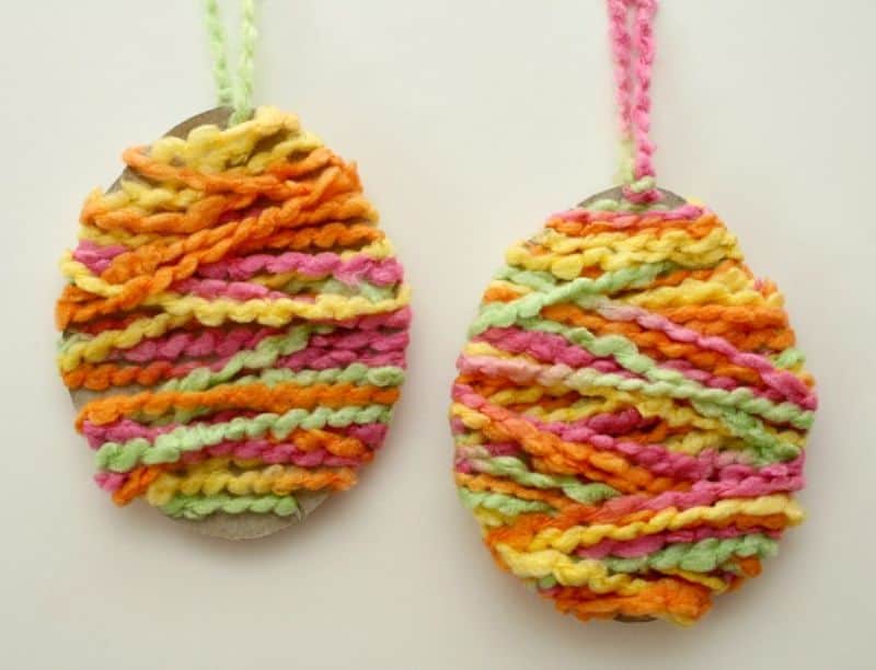 cardboard eggs wrapped in colorful yarn