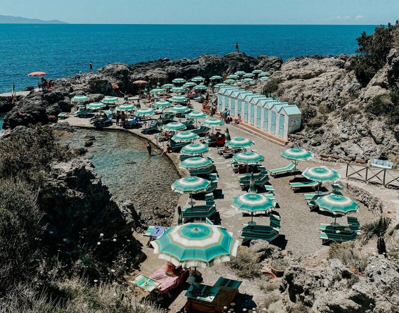Bagno Delle Donne beach in italy with lounge chairs.