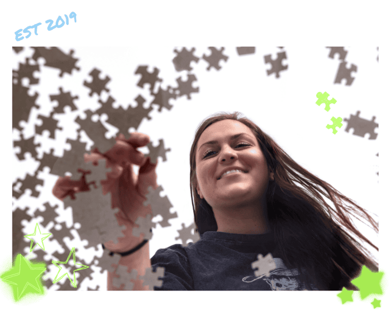 Kathryn Elliot, Accountant at Paragon Accounting & Tax Solutions, assembling a jigsaw puzzle from a creative low-angle perspective in Georgia, USA.