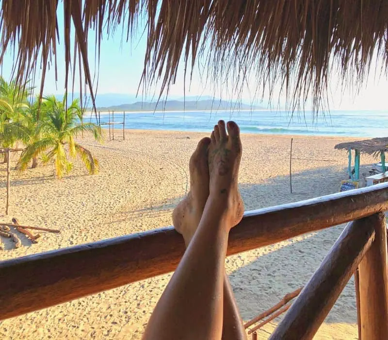 feet up on a ledge at Playa Chacahua in Lagunas de Chacahua, Oaxaca, Mexico