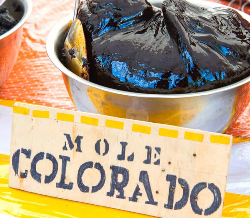 selling mole at a market in oaxaca