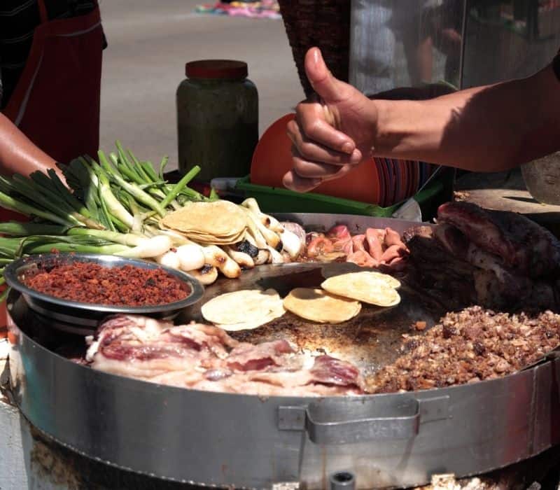man preparing street food in oaxaca mexico