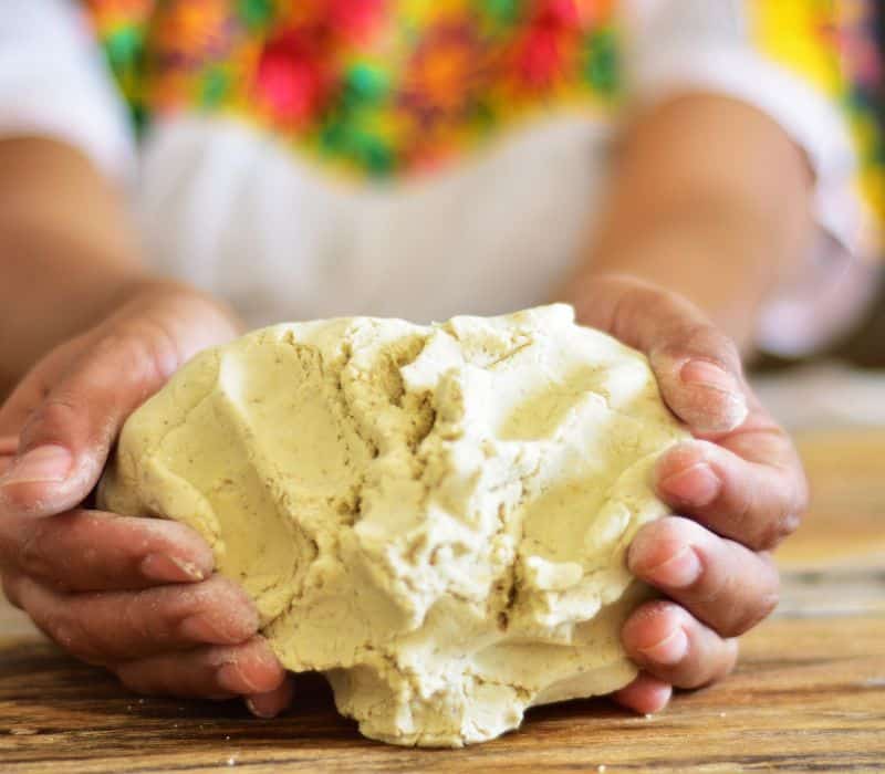 woman holding ball of masa corn dough