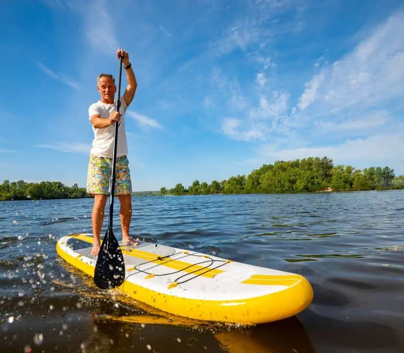 man doing SUP paddle boarding in Laguna Manialtepec Lagoon, puerto escondido oaxaca mexico