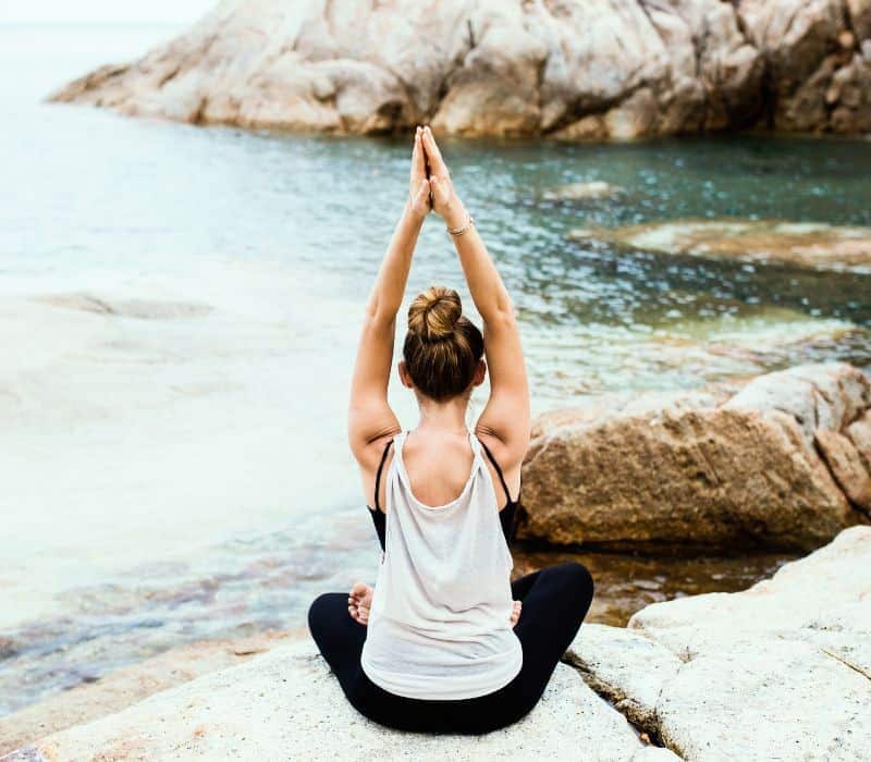 woman doing yoga on the beach in mazunte mexico