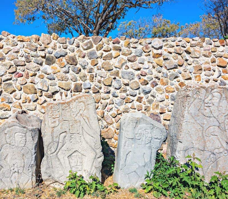 carved stone figures at monte alban ruins in oaxaca mexico
