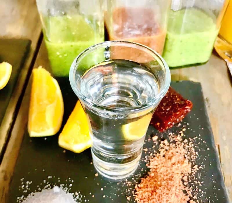 cup of mezcal with accompaniments 