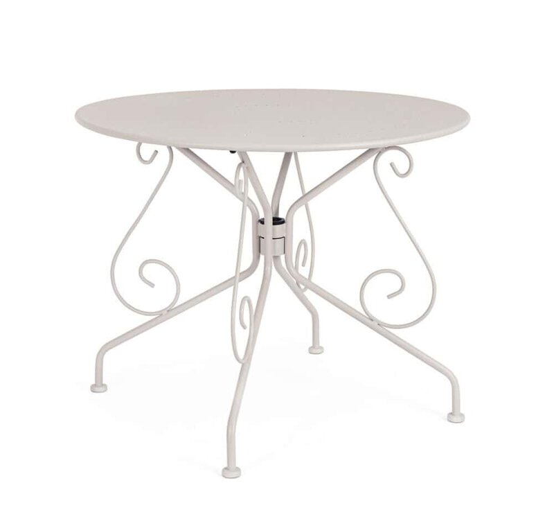 Tavolo rotondo in ferro battuto bianco con piano in cemento, stile vintage e design elegante.