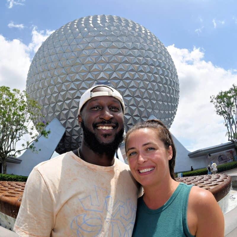 Epcot Spaceship Earth at Walt Disney World with happy couple enjoying a vacation in Orlando.