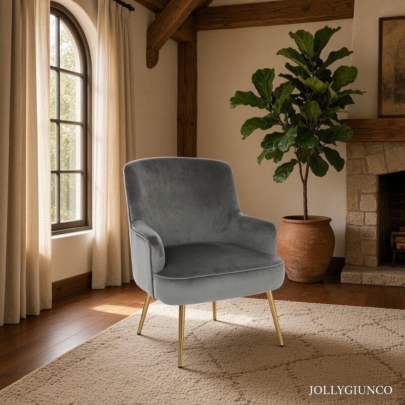 Blue velvet armchair with gold legs in a sunlit living room beside a large potted plant.
