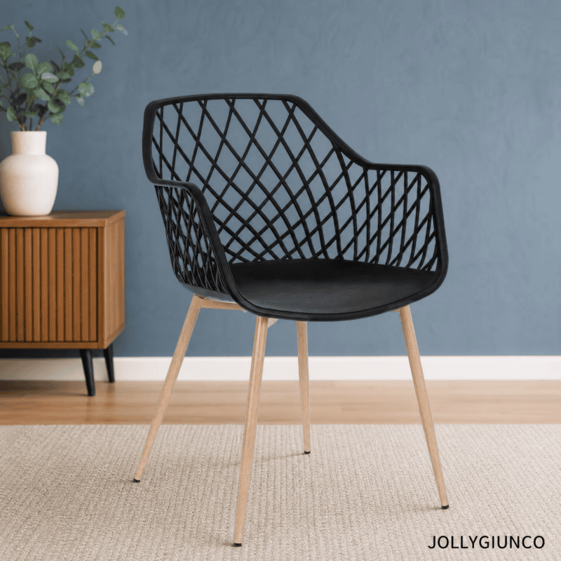 Black lattice-back chair with light wood legs in a modern living space, blue wall behind and a plant on a side table nearby.