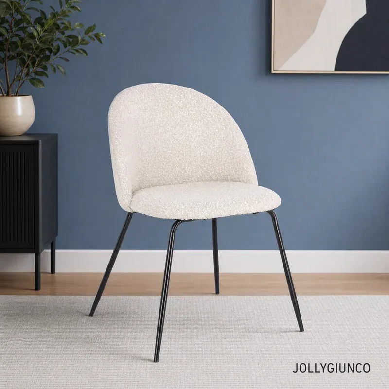 White textured chair with black legs in a blue-walled room, with a plant on a black cabinet and abstract art in the background.