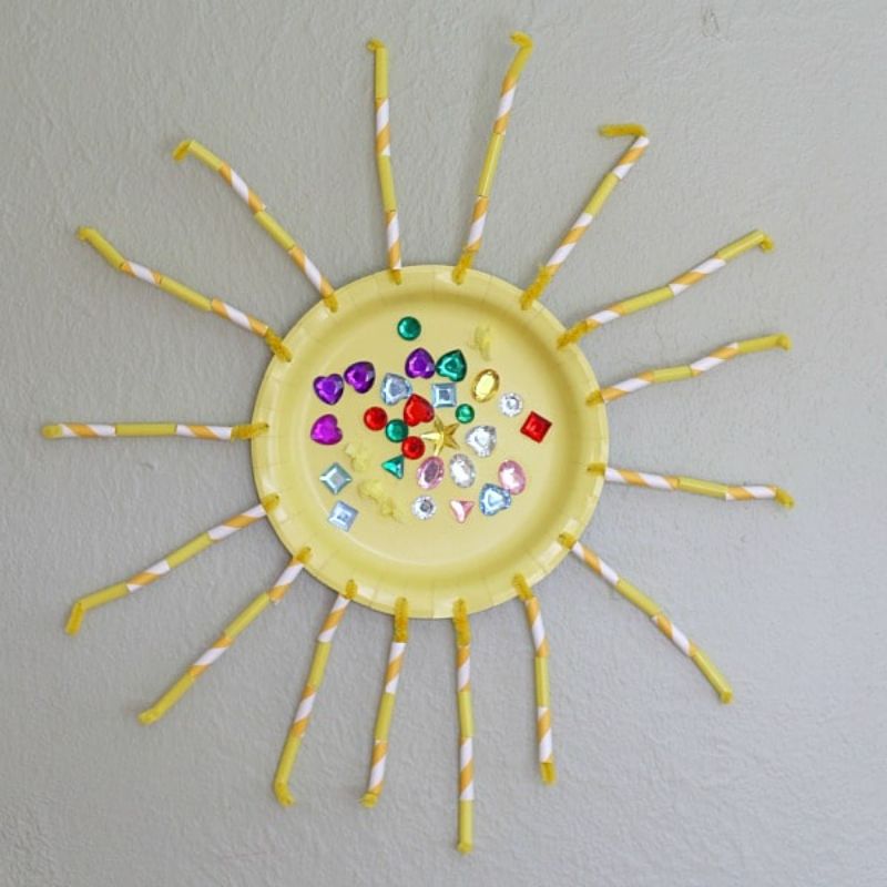 sun craft made of straws and a paper plate