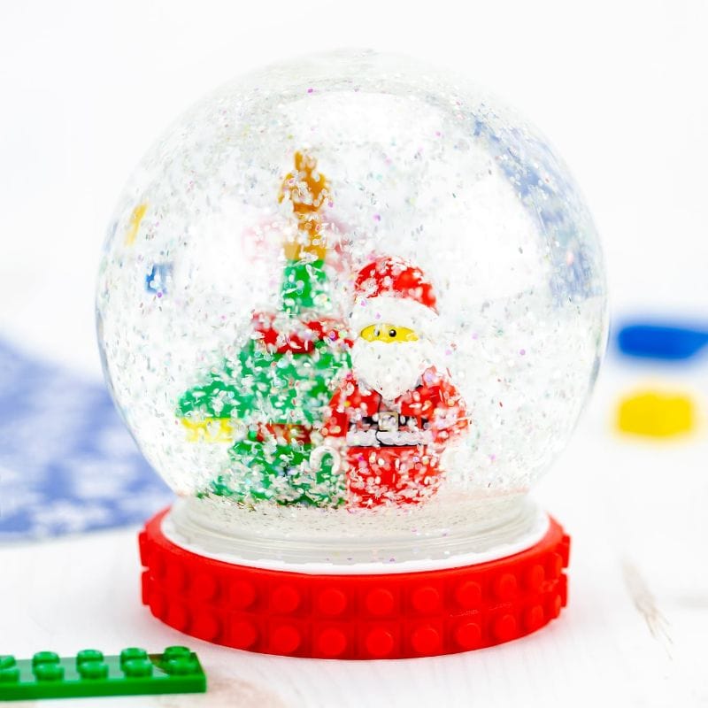 handmade snow globe with lego mini figure and tree inside