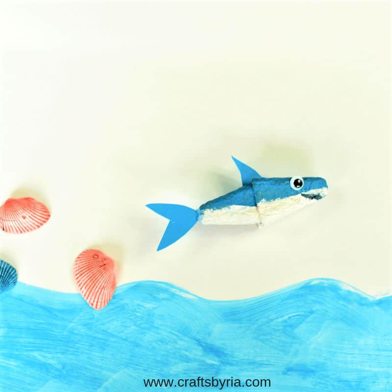 egg carton shark on ocean-themed background