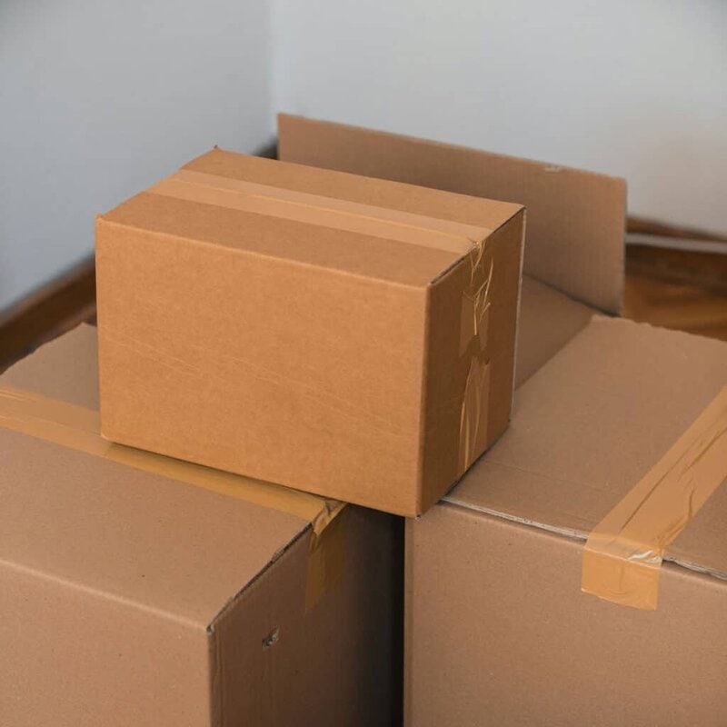 Cardboard boxes stacked in a clean storage unit to demonstrate different unit sizes.