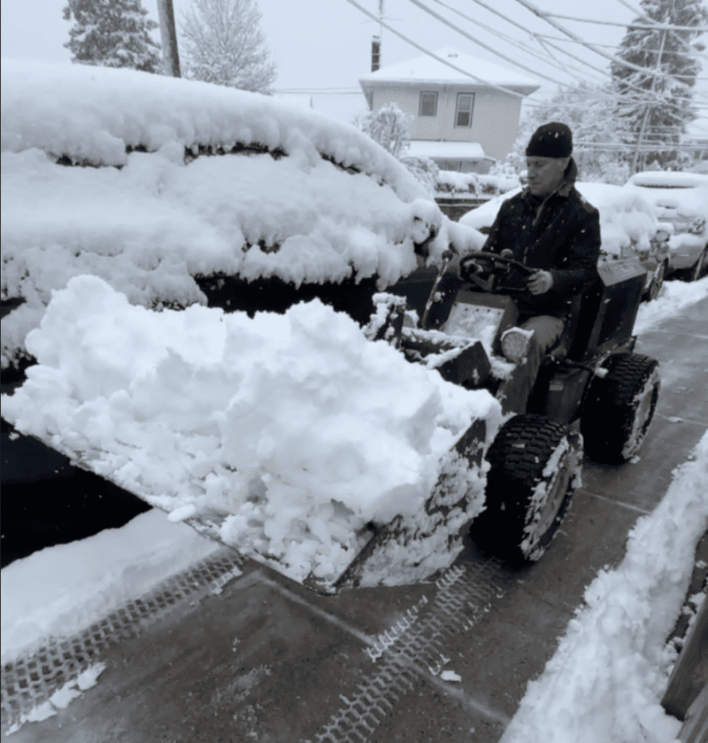 Mark scooping snow with the tractor which is one of the best snow tools