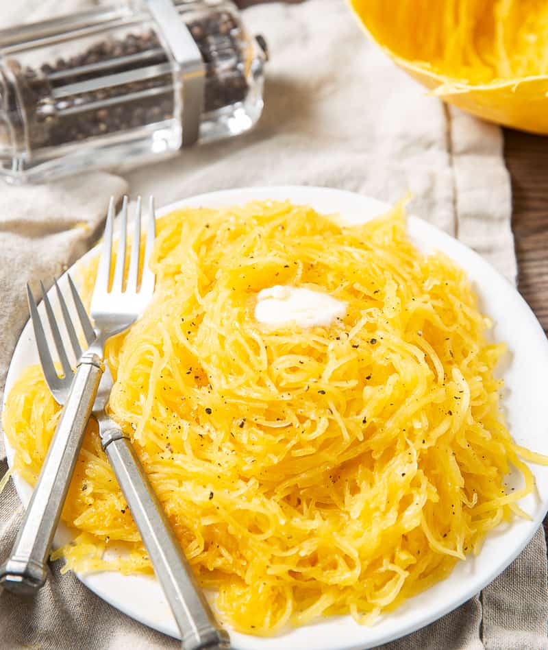 spaghetti squash on plate with butter and pepper