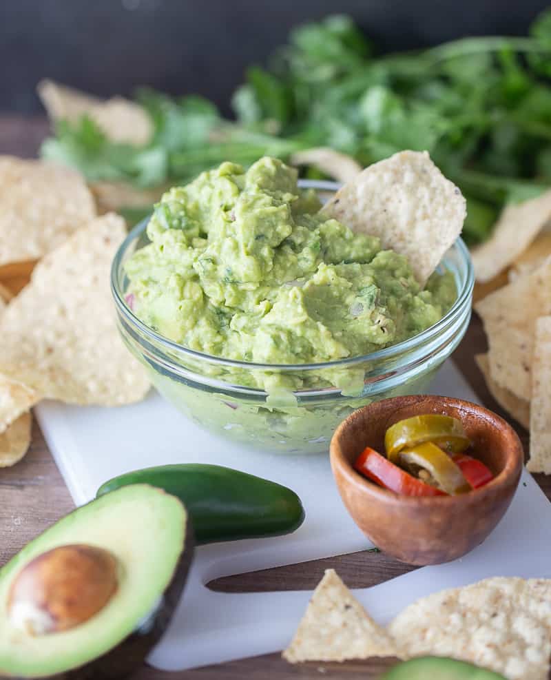 the best guacamole recipe - guacamole with a chip in the bowl