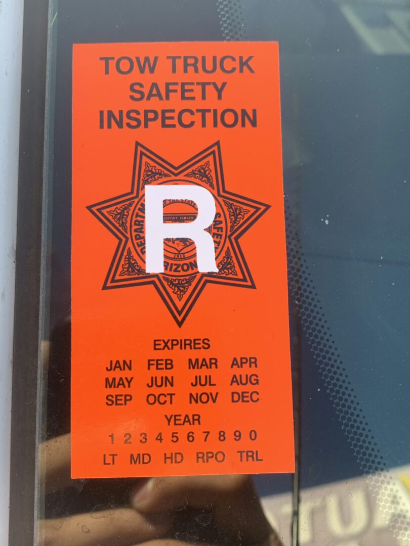 Arizona DPS tow truck inspection orange sticker displayed on Freeway Towing & Storage vehicle in Phoenix