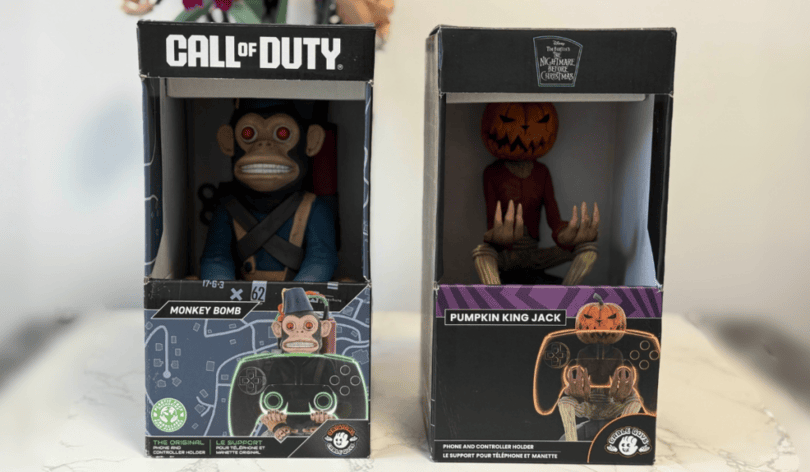 Two collectible cable guys controller holder character figures in boxes: the Monkey Bomb from Call of Duty and Pumpkin King Jack from The Nightmare Before Christmas.